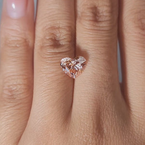 2.10ct Heart vivid pink diamond in warm handheld lighting