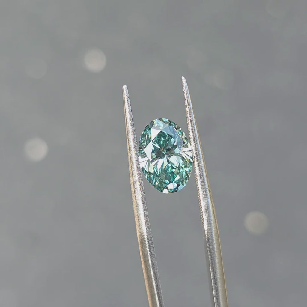 2.05ct oval brilliant cut fancy vivid blue VS1 lab diamond displaying rare blue color in outdoor sunlight.