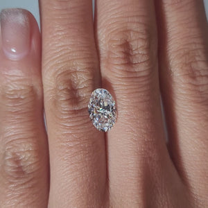 "Hand-modeled video of 2.226ct oval diamond in warm indoor lighting showcasing sparkle"