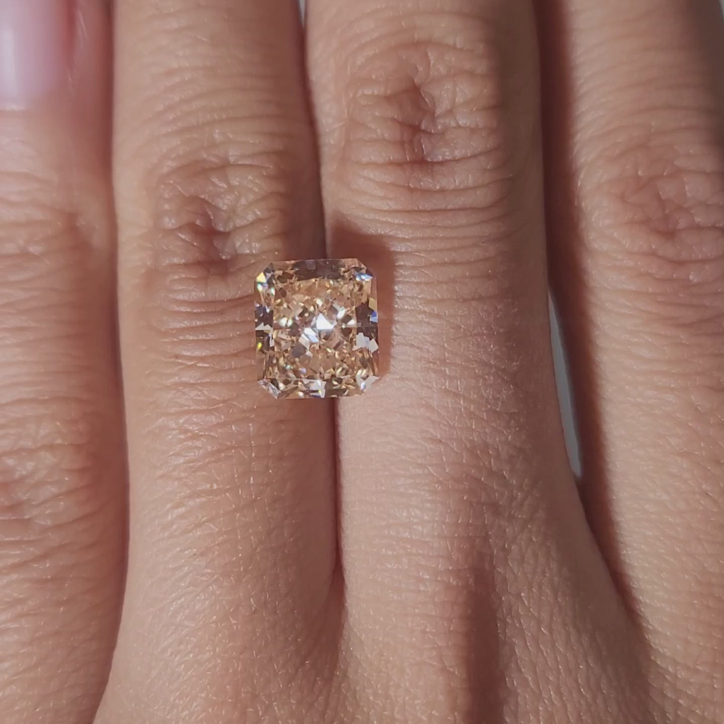 hand comparison video of 3.65ct orange radiant diamond