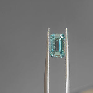 Natural light video highlighting 2.012ct emerald cut's clean lines and blue depth