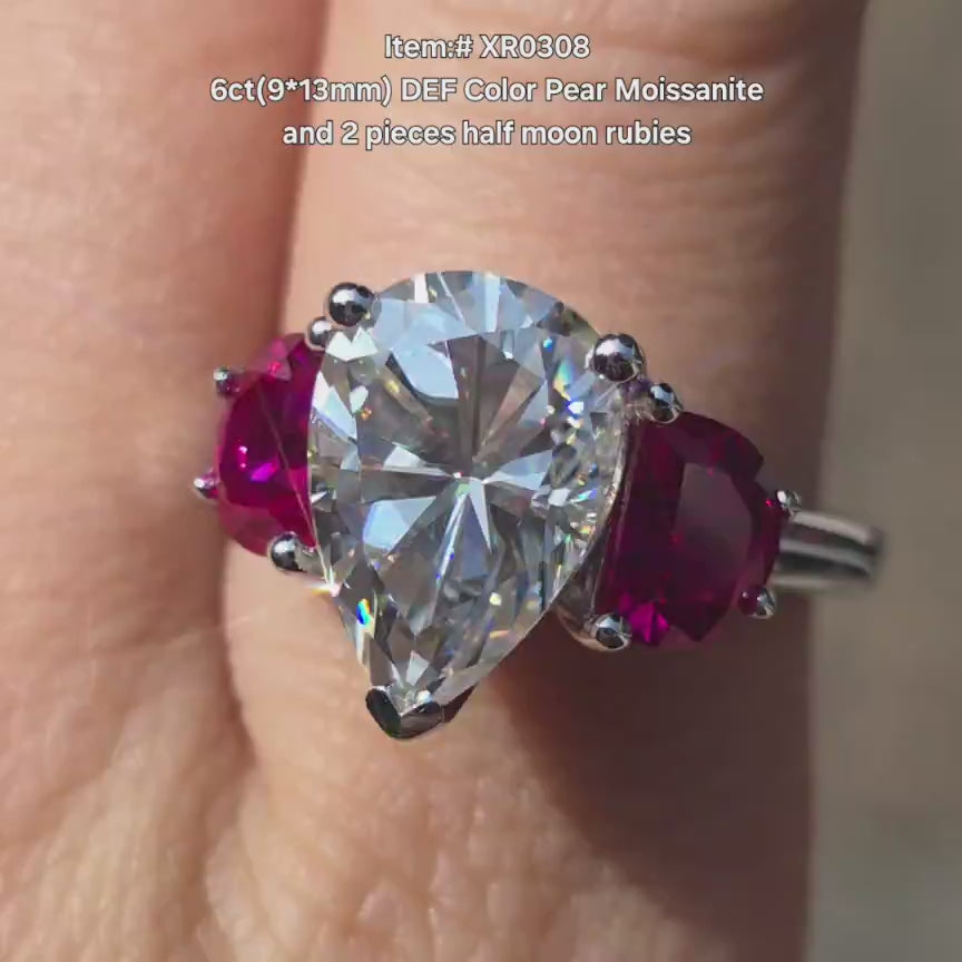 DovEggs Pear moissanite engagement ring with half moon moissanite side stone sparkling in sunlight video.