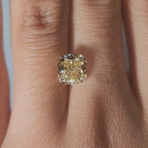 Hand-modeled video in candlelight showing  cushion lab diamond