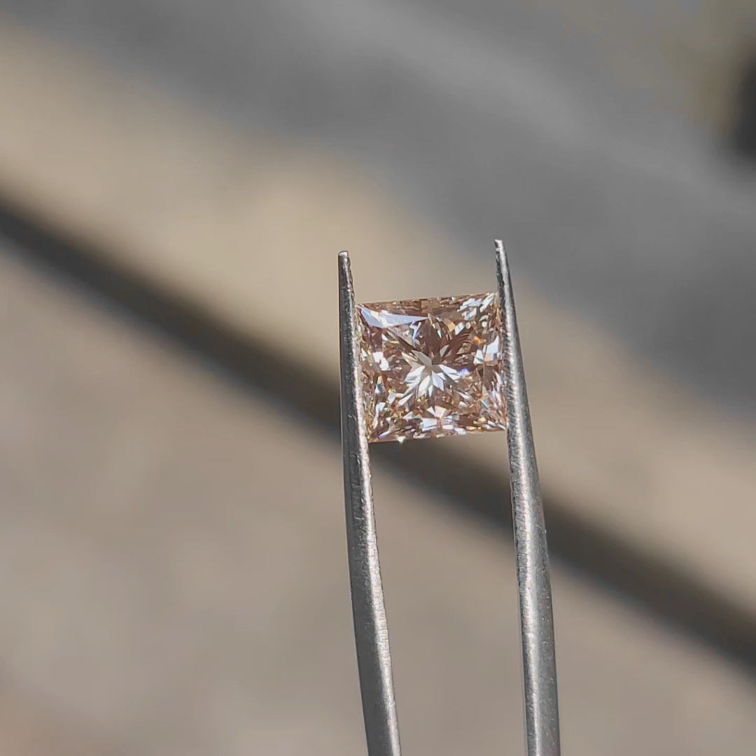 Sunlight video capturing 3.12ct princess cut's fiery orange glow
