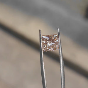 Sunlight video capturing 3.12ct princess cut's fiery orange glow