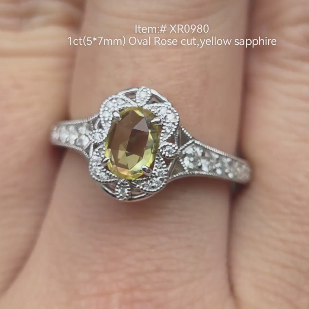 1ct oval rose cut yellow sapphire engagement ring with vintage diamond halo and filigree milgrain band, shown on hand in natural light