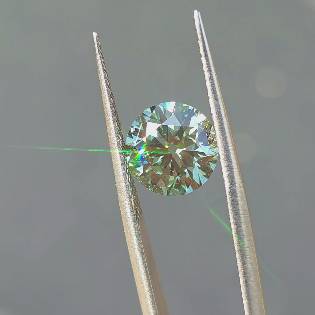 3.23ct round old European cut fancy vivid green VVS1 lab diamond showing intense color in outdoor sunlight.
