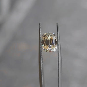 2.73ct cushion cut fancy orange diamond in natural light, showing vintage-inspired faceting
