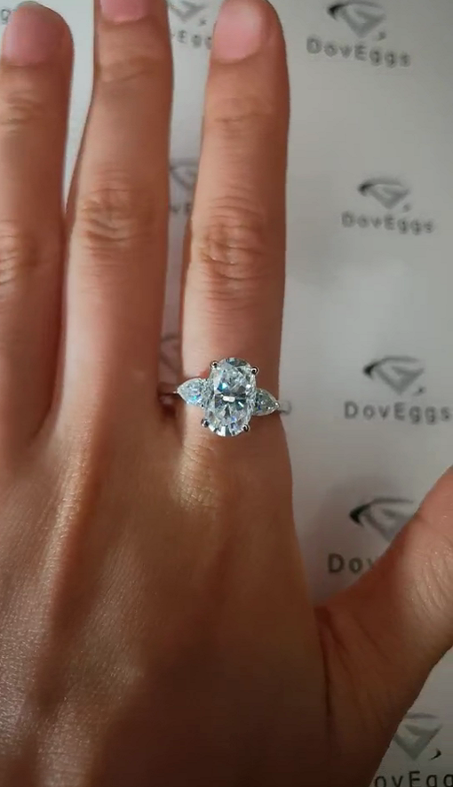 DovEggs elongated oval three-stone moissanite engagement ring